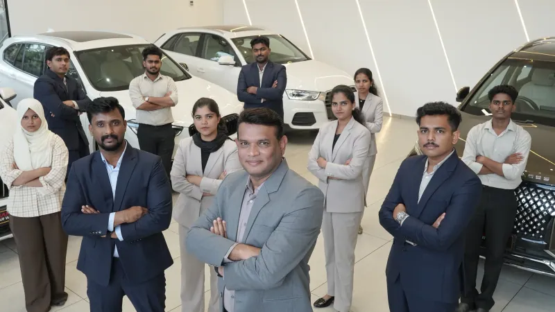 The owner and staff of Manu’s Car World together at the showroom